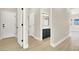 Hallway leading to a bathroom featuring light wood floors and modern white doors at 5908 Big Horn View St, North Las Vegas, NV 89031