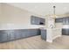 New kitchen featuring modern grey cabinets, island with seating, and stainless appliances at 5908 Big Horn View St, North Las Vegas, NV 89031
