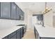 Stylish kitchen features sleek countertops, grey cabinetry, and stainless-steel appliances at 5908 Big Horn View St, North Las Vegas, NV 89031