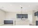 Bright kitchen with grey cabinetry, a center island, and modern lighting at 5908 Big Horn View St, North Las Vegas, NV 89031