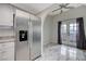 Kitchen with stainless steel refrigerator, light countertop, and white cabinets with access to a sunroom at 6109 W Oakey Blvd # C, Las Vegas, NV 89146