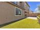 Landscaped backyard features green grass area and a paved patio space at 6370 Ava Ridge Ave, Las Vegas, NV 89141