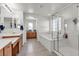 Bathroom featuring a bathtub, walk-in shower, and double sink vanity at 6370 Ava Ridge Ave, Las Vegas, NV 89141