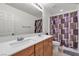 Bathroom featuring a double vanity, a shower and tub combo, and a neutral color scheme at 6370 Ava Ridge Ave, Las Vegas, NV 89141