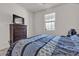 Bedroom features a dresser with a tv, blue patterned sheets and natural light at 6370 Ava Ridge Ave, Las Vegas, NV 89141