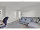 Bright bedroom with a plush carpet, light blue sofa and a closet at 6370 Ava Ridge Ave, Las Vegas, NV 89141
