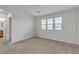 Bedroom with neutral carpet, bright white walls, and access to the ensuite bathroom at 6370 Ava Ridge Ave, Las Vegas, NV 89141