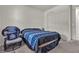 This bedroom has a chair and a bed with blue patterned sheets at 6370 Ava Ridge Ave, Las Vegas, NV 89141