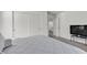 Bedroom with a tv, neutral carpet, white walls, and closet with sliding doors at 6370 Ava Ridge Ave, Las Vegas, NV 89141
