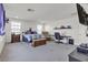 Spacious bedroom featuring a desk, chair, TV, and carpeted floors at 6370 Ava Ridge Ave, Las Vegas, NV 89141