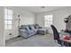 Bright bedroom features plush carpet, light blue sofa with throw pillows, and natural light at 6370 Ava Ridge Ave, Las Vegas, NV 89141