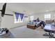 Spacious bedroom with abundant natural light, neutral carpet, and a cozy seating area at 6370 Ava Ridge Ave, Las Vegas, NV 89141