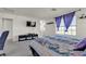 Bedroom featuring a large window with blinds and a television at 6370 Ava Ridge Ave, Las Vegas, NV 89141