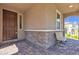 Inviting covered front porch with stone accents, offering a cozy bench and charming exterior details at 6370 Ava Ridge Ave, Las Vegas, NV 89141