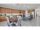 Spacious kitchen featuring wood cabinets, stainless steel appliances, and a large island with bar seating at 6370 Ava Ridge Ave, Las Vegas, NV 89141