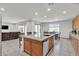 Bright, open kitchen features a center island with light wood cabinets and adjacent living area at 6370 Ava Ridge Ave, Las Vegas, NV 89141