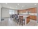 Bright kitchen with wood cabinets, a central island with bar seating, and a cozy breakfast nook at 6370 Ava Ridge Ave, Las Vegas, NV 89141