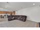 Spacious living room featuring a plush sectional sofa and tile flooring at 6370 Ava Ridge Ave, Las Vegas, NV 89141