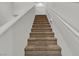 Carpeted stairway leading to the upper level of the home with bright walls and white painted trim at 6370 Ava Ridge Ave, Las Vegas, NV 89141
