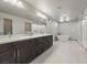 Bathroom with double sinks, soaking tub, glass shower, and tile flooring at 6618 Tangled Vines Ave, Las Vegas, NV 89139
