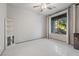Bright bedroom featuring tile floors, ceiling fan, and large windows with views at 6618 Tangled Vines Ave, Las Vegas, NV 89139