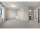 Bright bedroom features neutral walls, carpet, and views from the window at 6618 Tangled Vines Ave, Las Vegas, NV 89139
