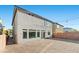 Back of the home featuring a brick-paved patio and exterior lighting at 6618 Tangled Vines Ave, Las Vegas, NV 89139