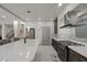 Spacious modern kitchen with large island, stainless appliances, dark cabinets, and pendant lighting at 6618 Tangled Vines Ave, Las Vegas, NV 89139