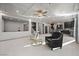 Spacious living area featuring tile flooring, a coffered ceiling, and an open layout connected to the kitchen at 6618 Tangled Vines Ave, Las Vegas, NV 89139