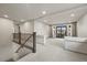 Upstairs loft area with carpeted floors, railing, and balcony with glass doors at 6618 Tangled Vines Ave, Las Vegas, NV 89139