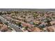 Wide aerial view of a planned community showing homes with pools, solar panels, and lush landscaping at 700 Red Bark Ln, Henderson, NV 89011