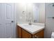 Bathroom vanity featuring sink, mirror, and storage, next to door at 700 Red Bark Ln, Henderson, NV 89011