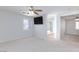 Bright bedroom with ceiling fan, TV, and attached bath with glass-door shower at 700 Red Bark Ln, Henderson, NV 89011
