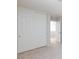 Bedroom with sliding-door closet and neutral carpet, next to entry door at 700 Red Bark Ln, Henderson, NV 89011