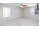 Spacious bedroom featuring a ceiling fan and natural light from two windows at 700 Red Bark Ln, Henderson, NV 89011