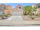 Charming single-Gathering home featuring a well-maintained front yard and attached two-car garage at 700 Red Bark Ln, Henderson, NV 89011