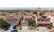 View of residential houses that feature tile roofs, solar panels, and two-car garages at 700 Red Bark Ln, Henderson, NV 89011