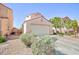 Single-Gathering home boasts a two-car garage and desert landscaping for low maintenance living at 700 Red Bark Ln, Henderson, NV 89011