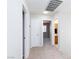 Light-filled hallway with carpet and access to multiple rooms at 700 Red Bark Ln, Henderson, NV 89011