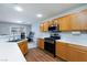 Bright kitchen features wooden cabinetry, white countertops, stainless steel appliances, and wood-look flooring at 700 Red Bark Ln, Henderson, NV 89011