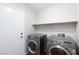 Laundry room featuring front-load washer and dryer and storage shelf at 700 Red Bark Ln, Henderson, NV 89011