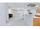 Open concept living space with gray walls, carpet, kitchen access, and ceiling fan at 700 Red Bark Ln, Henderson, NV 89011