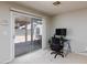 Bright office space with sliding glass door to the backyard and a modern computer desk at 700 Red Bark Ln, Henderson, NV 89011