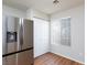 Bright pantry area with stainless refrigerator, white closet doors, and window with blinds at 700 Red Bark Ln, Henderson, NV 89011