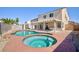 Enjoy a backyard oasis featuring a pool, hot tub, covered patio, and lush landscaping at 700 Red Bark Ln, Henderson, NV 89011