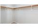 Spacious walk-in closet with neutral carpet and simple rod and shelving at 700 Red Bark Ln, Henderson, NV 89011