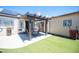 Backyard with artificial turf, a patio with a pergola, and a storage shed at 7231 Sequoia Springs Dr, Las Vegas, NV 89147
