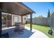 Backyard features artificial turf, covered patio with outdoor furniture, and storage shed at 7231 Sequoia Springs Dr, Las Vegas, NV 89147