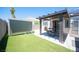 Backyard with artificial turf, patio area, pergola, block wall, and storage shed at 7231 Sequoia Springs Dr, Las Vegas, NV 89147
