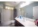 Bright bathroom featuring a vanity with a sink, a large mirror, and a shower-tub combo at 7231 Sequoia Springs Dr, Las Vegas, NV 89147